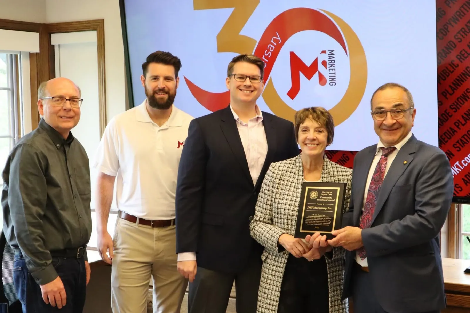 a photo of the jms team with the mayor of crystal lake in recognition of our 30th anniversary